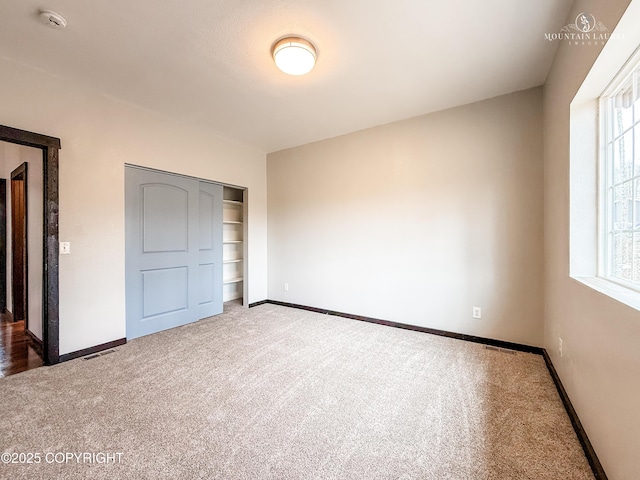 1340 N Rainbow Park Dr, Wasilla, AK 99623 - unfurnished bedroom featuring baseboards, carpet flooring, and multiple windows