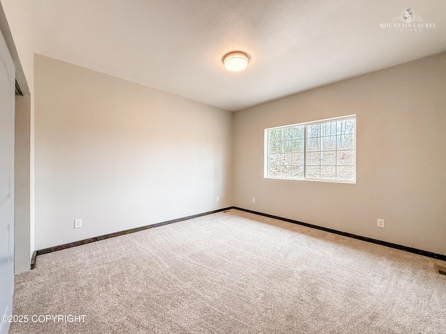 1340 N Rainbow Park Dr, Wasilla, AK 99623 - spare room featuring baseboards and carpet