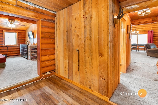interior space featuring wooden ceiling, rustic walls, and wood finished floors