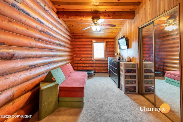 sitting room featuring log walls, carpet, wood ceiling, and a ceiling fan