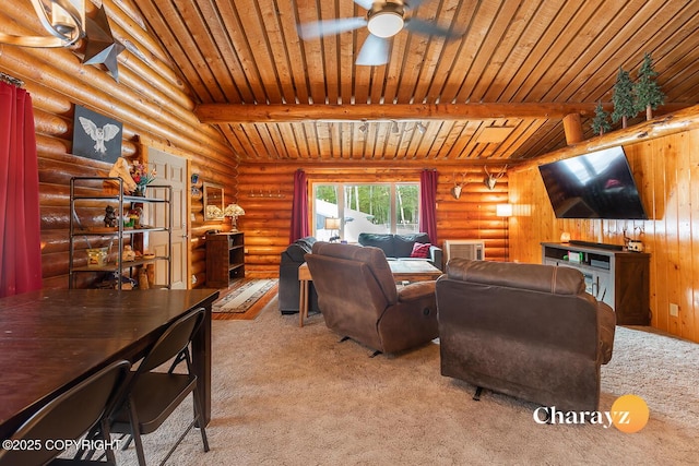 carpeted living area with beam ceiling, a ceiling fan, wooden ceiling, and rustic walls