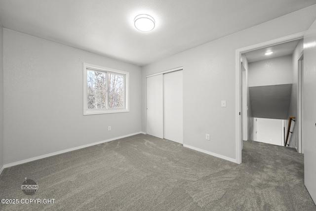 unfurnished bedroom with baseboards, carpet, and a closet