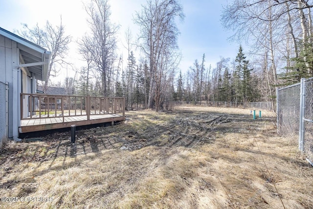view of yard featuring fence and a deck