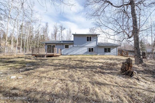 back of house featuring a fenced backyard and a deck
