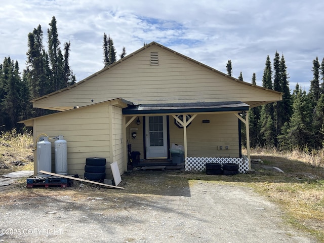 30258 Hook Ln, Soldotna, AK 99669 - bungalow-style house with entry steps and a view of trees