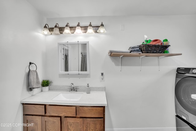 bathroom with washer / clothes dryer and vanity