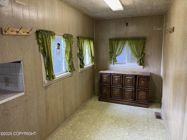 corridor with wood walls and visible vents