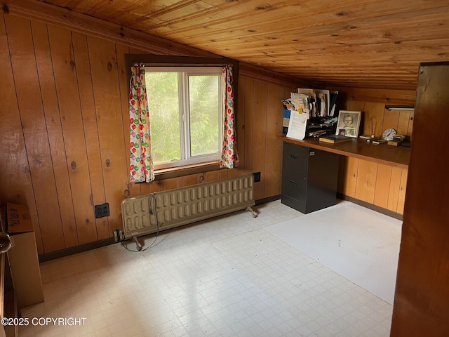interior space featuring wooden walls, radiator heating unit, wooden ceiling, and light floors
