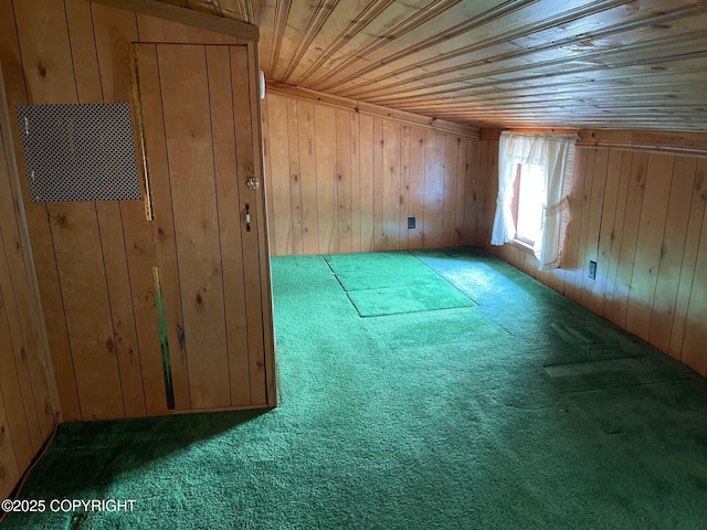 additional living space featuring carpet, wood walls, and wood ceiling