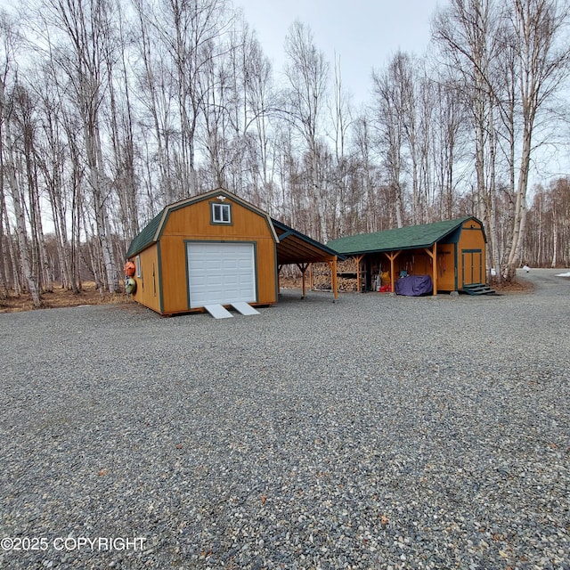 garage with a detached garage and driveway