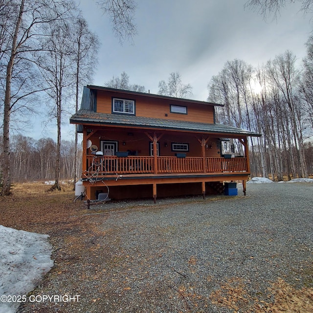 chalet / cabin with metal roof and covered porch