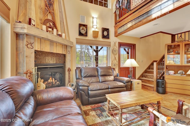 49635 S Hunter Dr, Willow, AK 99688 - living area featuring a towering ceiling, stairway, and a glass covered fireplace