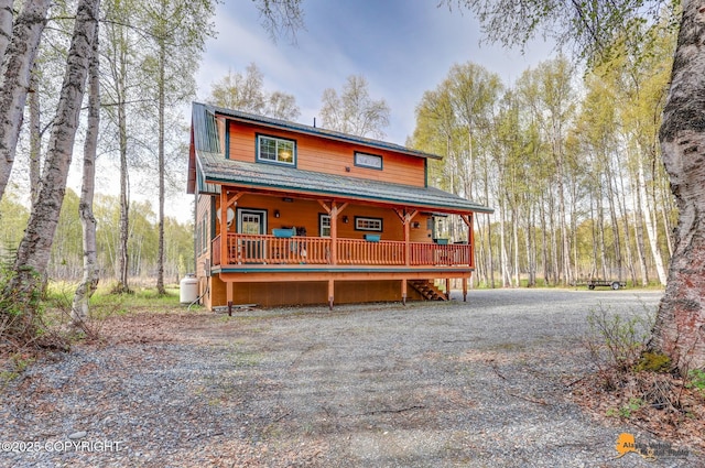 49635 S Hunter Dr, Willow, AK 99688 - rustic home featuring a porch, metal roof, and stairs
