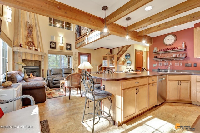 49635 S Hunter Dr, Willow, AK 99688 - kitchen featuring light brown cabinets, stainless steel dishwasher, a sink, open floor plan, and pendant lighting