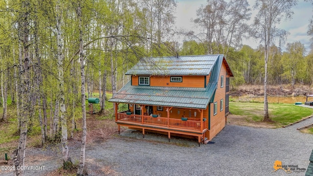 49635 S Hunter Dr, Willow, AK 99688 - chalet / cabin with a porch, metal roof, and a wooded view