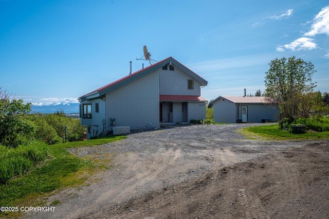 2435 Paradise Pl, Homer, AK 99603 - view of property exterior featuring driveway and metal roof
