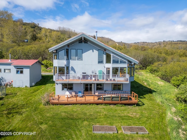 2435 Paradise Pl, Homer, AK 99603 - back of property featuring a balcony, a yard, a wooded view, and a deck