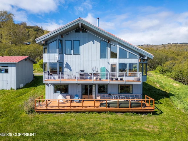2435 Paradise Pl, Homer, AK 99603 - back of house with a balcony, a lawn, and a view of trees