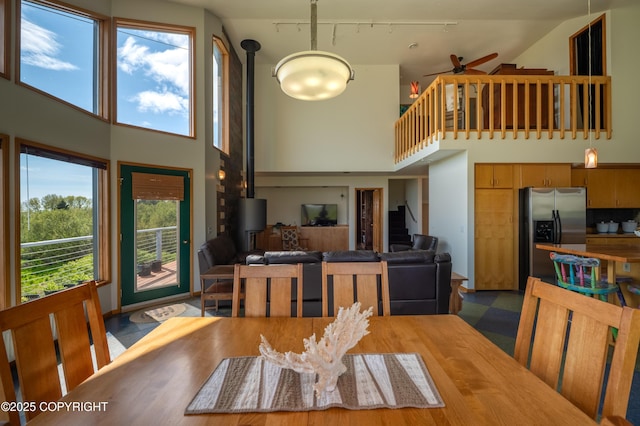 2435 Paradise Pl, Homer, AK 99603 - dining room with a high ceiling, stairs, a ceiling fan, and rail lighting
