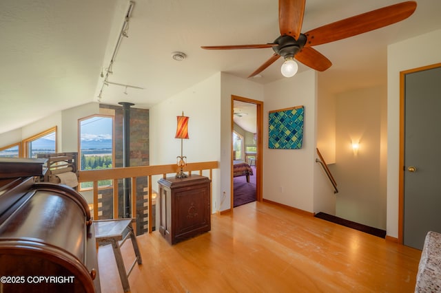2435 Paradise Pl, Homer, AK 99603 - living area with an upstairs landing, wood finished floors, ceiling fan, and rail lighting