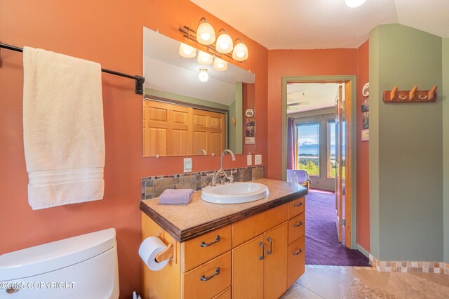 2435 Paradise Pl, Homer, AK 99603 - bathroom with toilet, vanity, tile patterned flooring, and baseboards
