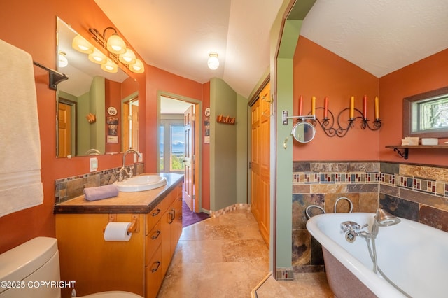 2435 Paradise Pl, Homer, AK 99603 - full bath featuring a freestanding tub, vanity, toilet, and lofted ceiling