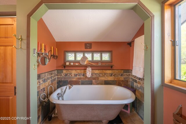 2435 Paradise Pl, Homer, AK 99603 - full bath with vaulted ceiling, a freestanding tub, and tile walls