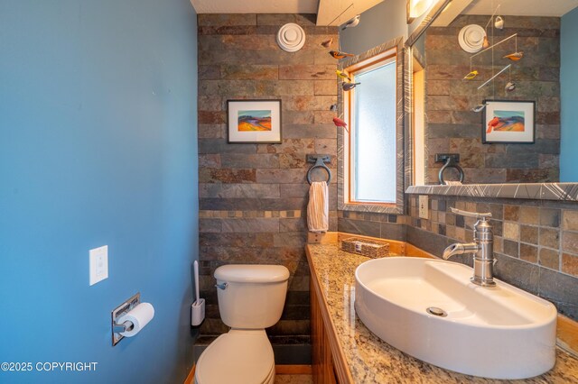 2435 Paradise Pl, Homer, AK 99603 - bathroom with toilet, vanity, and tile walls