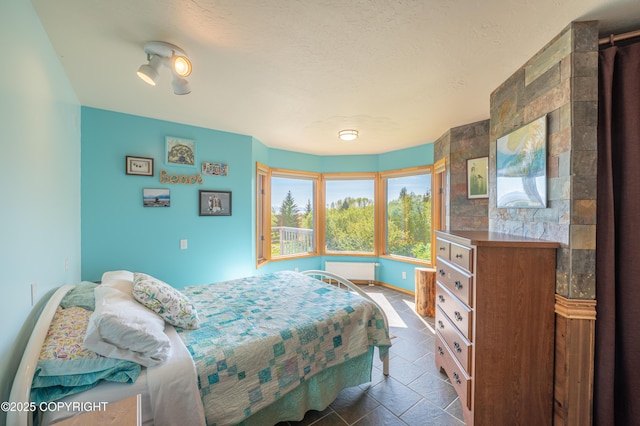 2435 Paradise Pl, Homer, AK 99603 - bedroom with radiator and stone tile flooring