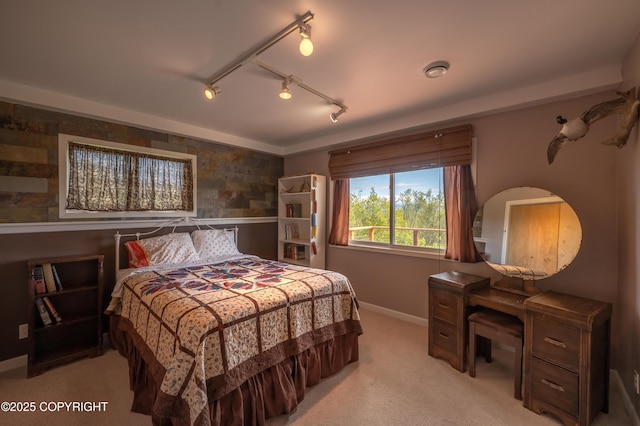 2435 Paradise Pl, Homer, AK 99603 - bedroom featuring light carpet, baseboards, and rail lighting