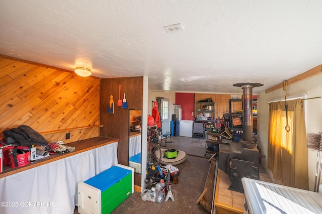 2435 Paradise Pl, Homer, AK 99603 - living area featuring a wood stove and wood walls