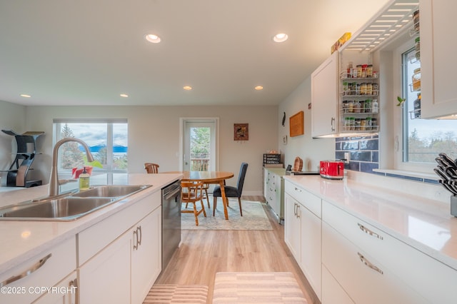 437 W Fairview Ave, Homer, AK 99603 - kitchen with a sink, recessed lighting, light wood-style flooring, stainless steel dishwasher, and white cabinets