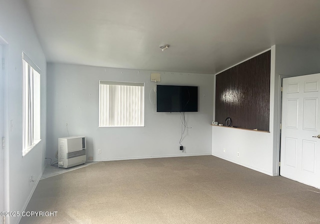 3698 Poppy Cir, Homer, AK 99603 - unfurnished living room with carpet, baseboards, and heating unit