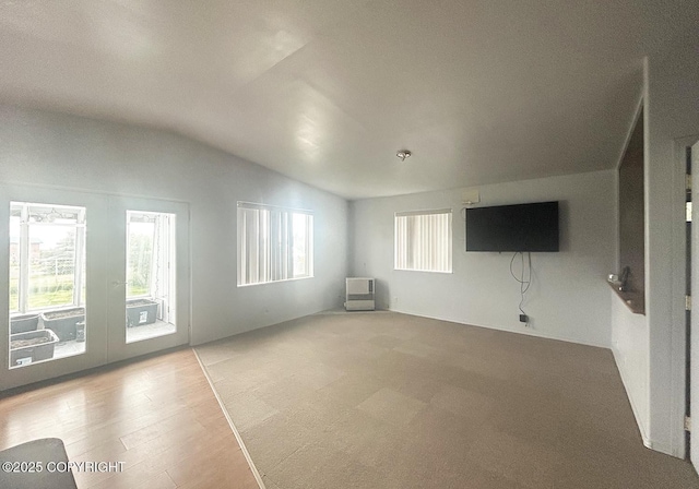 3698 Poppy Cir, Homer, AK 99603 - unfurnished living room with vaulted ceiling, plenty of natural light, french doors, and wood finished floors