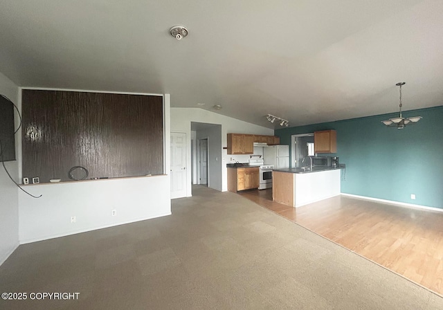 3698 Poppy Cir, Homer, AK 99603 - kitchen featuring range, open floor plan, dark carpet, vaulted ceiling, and a peninsula
