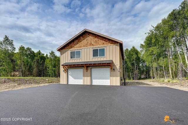 3696 S Alvaro Dr, Wasilla, AK 99654 - view of side of property with board and batten siding and a garage
