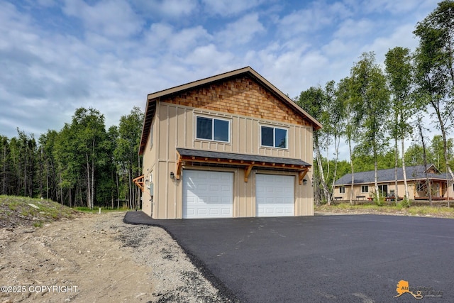 3696 S Alvaro Dr, Wasilla, AK 99654 - view of front facade featuring board and batten siding and a detached garage