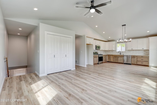 3696 S Alvaro Dr, Wasilla, AK 99654 - kitchen featuring appliances with stainless steel finishes, ceiling fan, pendant lighting, a chandelier, and light countertops