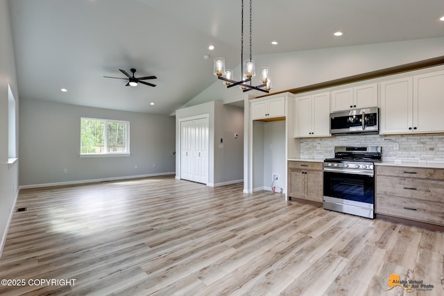 3696 S Alvaro Dr, Wasilla, AK 99654 - kitchen with stainless steel appliances, decorative backsplash, ceiling fan, light wood-type flooring, and light countertops