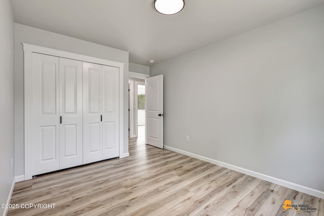 3696 S Alvaro Dr, Wasilla, AK 99654 - unfurnished bedroom featuring light wood-style flooring and a closet