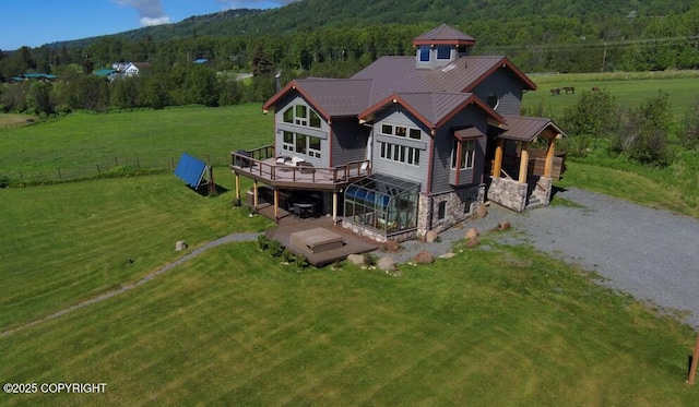 41345 Alan St, Homer, AK 99603 - exterior space with a lawn, stone siding, a deck, a view of trees, and gravel driveway