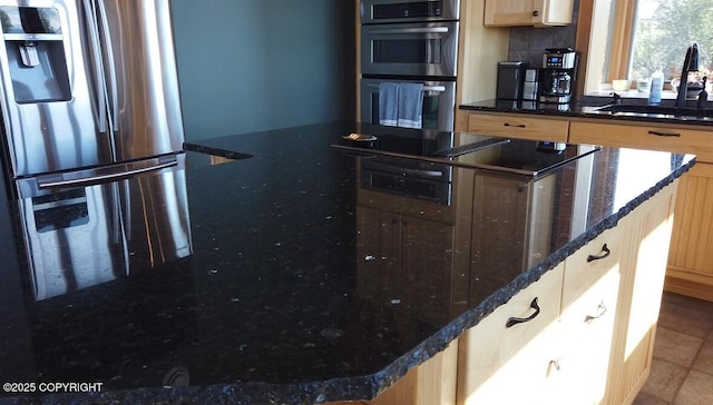 41345 Alan St, Homer, AK 99603 - kitchen featuring stainless steel appliances, dark stone countertops, light brown cabinets, a sink, and a center island