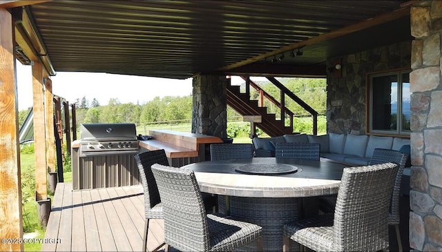 41345 Alan St, Homer, AK 99603 - wooden terrace with an outdoor kitchen, outdoor dining area, stairs, and a grill