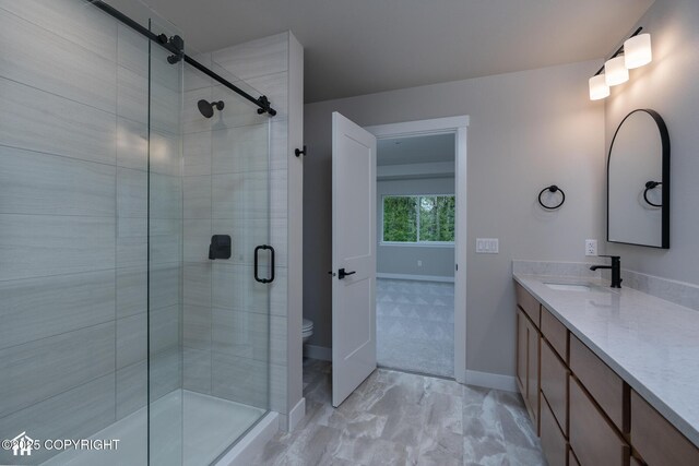 bathroom featuring a stall shower, baseboards, marble finish floors, and vanity