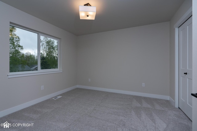 unfurnished bedroom with carpet flooring and baseboards