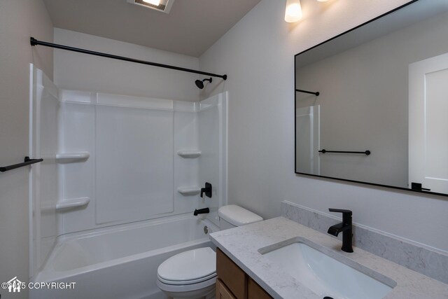 full bath featuring toilet, vanity, and bathing tub / shower combination