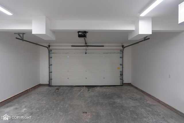 garage featuring baseboards and a garage door opener