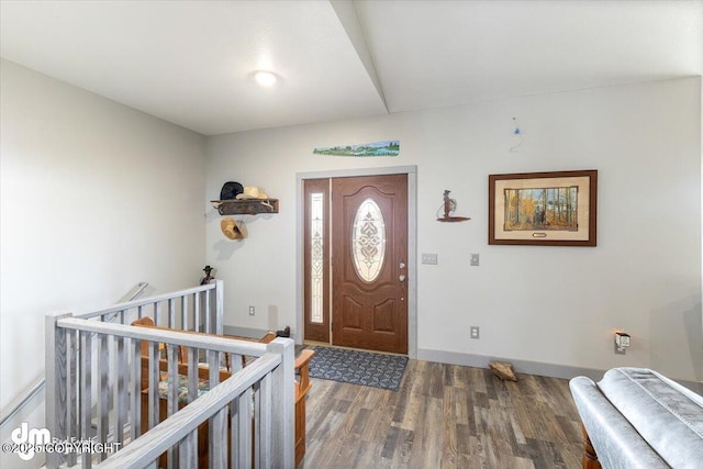 foyer with baseboards and wood finished floors