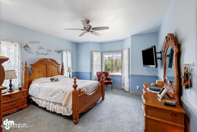 carpeted bedroom featuring baseboards and ceiling fan