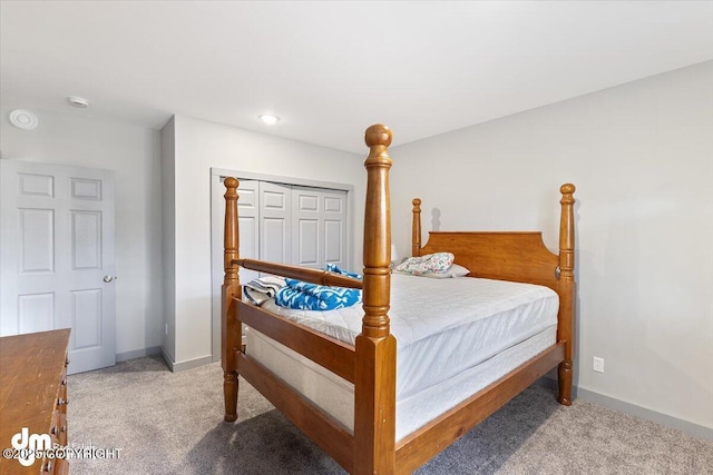 bedroom with baseboards and light colored carpet